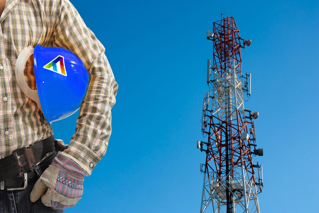technician against telecommunication tower, painted white and re